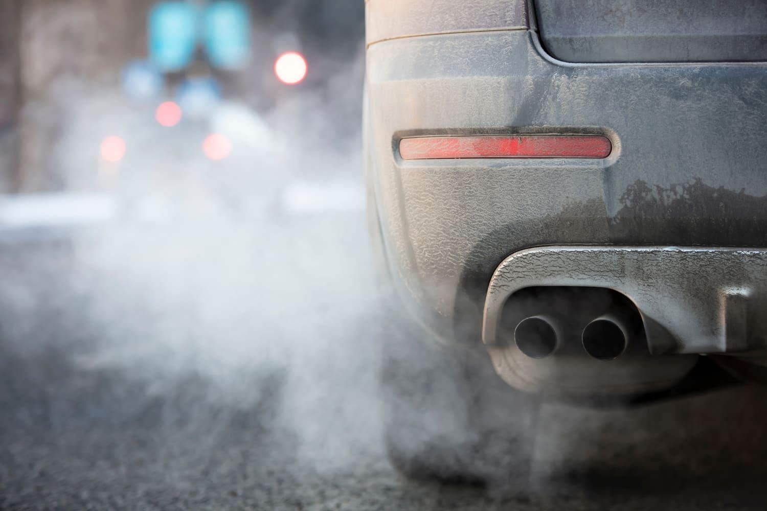 Exhaust fumes coming out of a dirty car