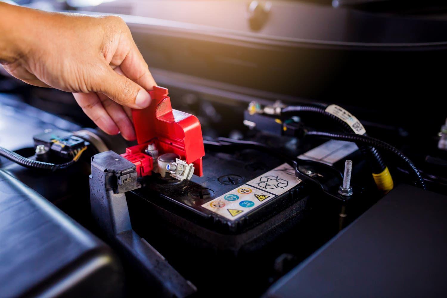 Mechanic replacing a car battery